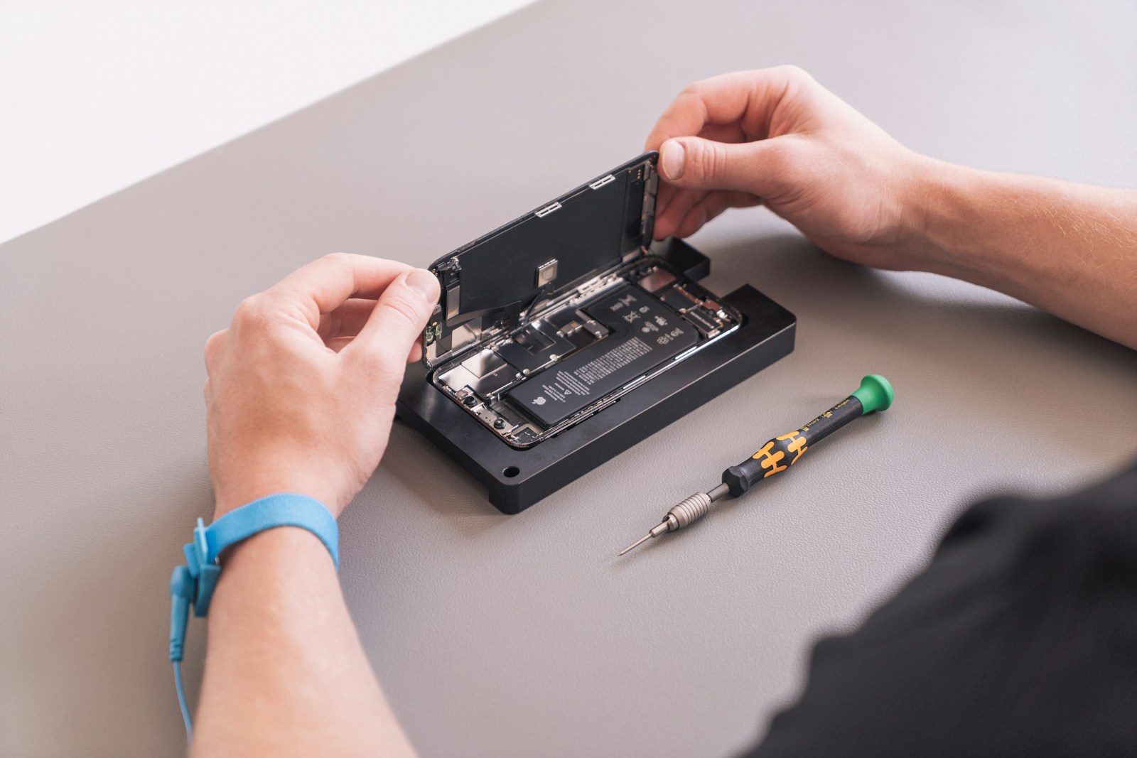 hands holding a black device